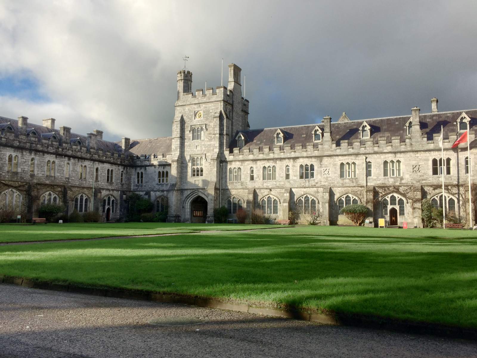 The Gothic Revival limestone Quadrangle of University College Cork, with a central crenellated tower above a wide green lawn